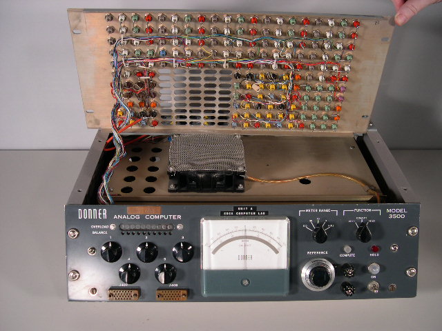 A view of the underside of the the Donner 3500 analog computer's patchboard.  You can also see the fan (covered by a screen) and the oblong openings that were used to dissipate the heat from the tubes.