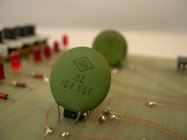  image of Closeup of ceramic capacitor w/ DATA switches in background. 